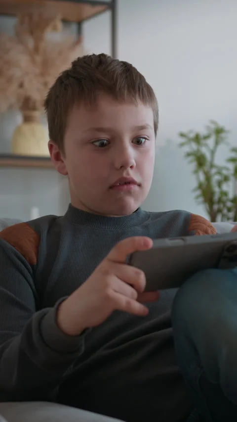 Boy Playing Video Game on Tablet Stock Footage 335486461