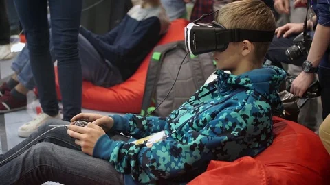 Boy playing video game with virtual reality VR glasses Stock Footage 69739579