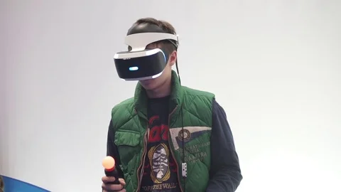 Boy playing video game with VR glasses Stock Footage 74364341