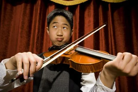 Boy playing violin Photos