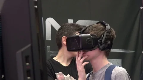 Boy playing a Virtual Reality game at a Comic-Con exposition Stock Footage 71964587