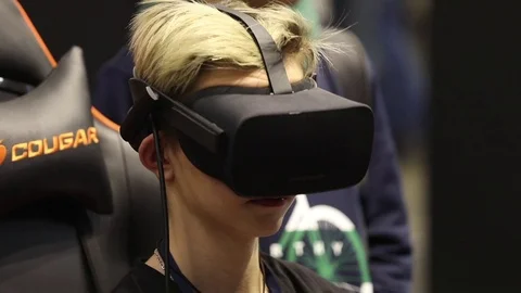 Boy playing virtual reality game in Oculus VR headset with accessories Stock Footage 81513665