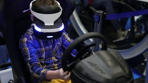 Boy playing virtual reality game in Sony VR headset with accessories controllers Stock Footage 81513753