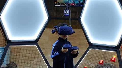 A boy playing Virtual Reality (VR) game in Shanghai Stock Footage 165633446