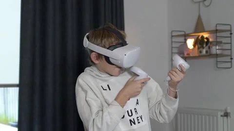 Boy playing with VR goggles shooting Stock Footage 146288958