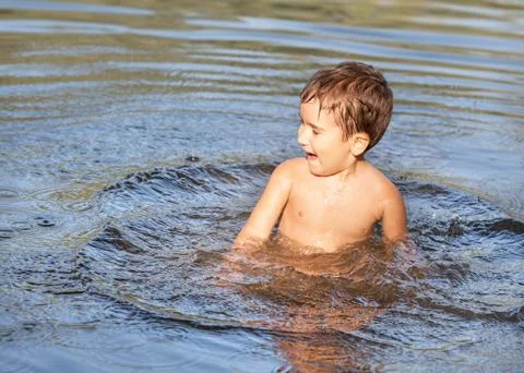 Boy playing in water Stock Photos