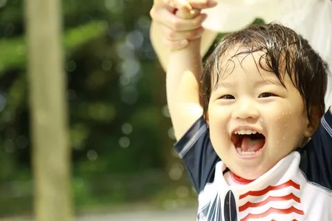 Boy playing in the water Stock Photos