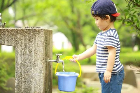 Boy playing in water Stock Photos