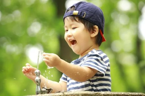 Boy playing in water Stock Photos