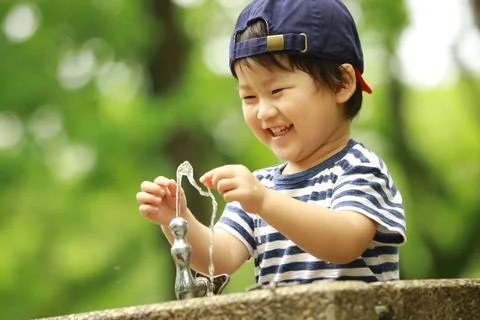 Boy playing in water Stock Photos