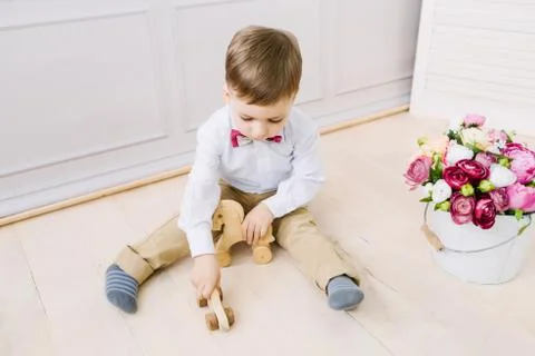 Boy playing while sitting on the floor Stock Photos