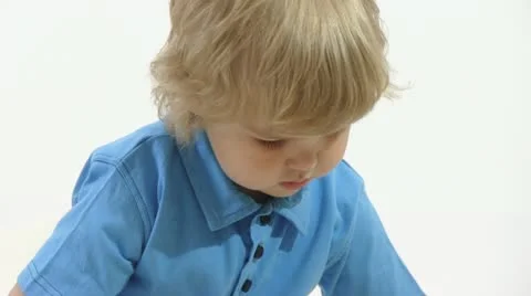 Boy playing in white room Stock Footage