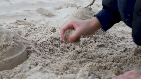 Boy playing in winter in the beach with sand Stock Footage 151590447