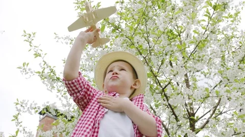 Boy playing wooden airplane Stock Footage 78557617