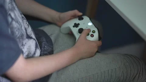 Boy playing Xbox one with Controller Stock Footage 136295690