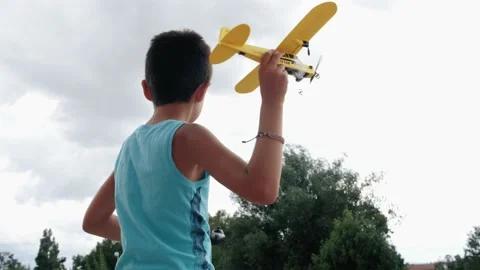 Boy plays with airplane, 4K Stock Footage 137023215