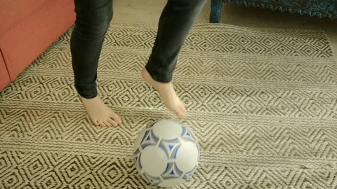 A boy plays with a ball in and around his house Stock Footage 308933457