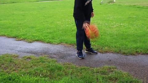 A boy plays with a basketball ball Stock Footage