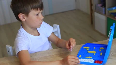 A boy plays a board game at home. Video stock 140368466