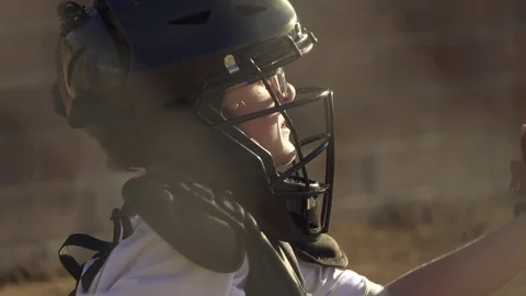 A boy plays catcher in a little league baseball game, super slow motion. Stock Footage