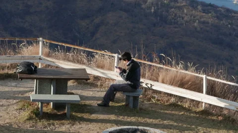 Boy plays on a cell phone instead of enjoying the view Stock Footage 59536874