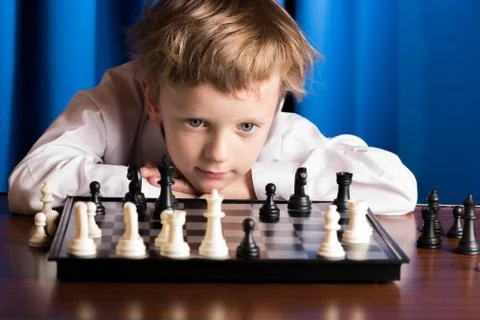 The boy plays chess Stock Photos