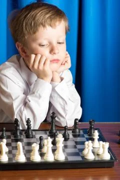 Boy plays chess Stock Photos