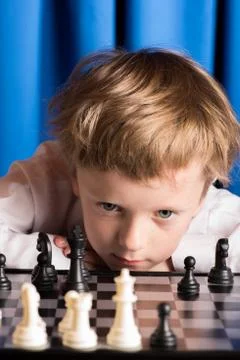 Boy plays chess Stock Photos