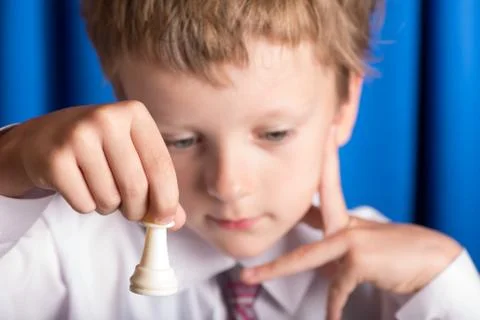 Boy plays chess Stock Photos