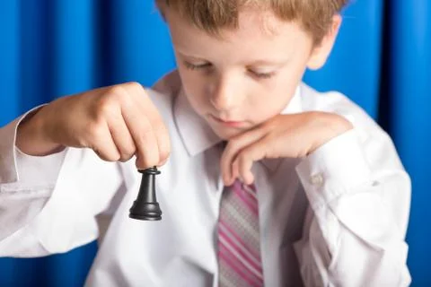 Boy plays chess Stock Photos