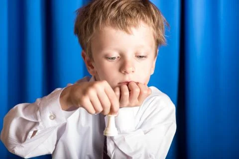 Boy plays chess Stock Photos
