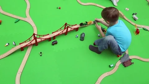 A boy plays on children's educational playground Видео 76812746