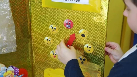 The boy plays with the clock.Instead of the numbers on the watch, the smiley. Stock Footage 129813258