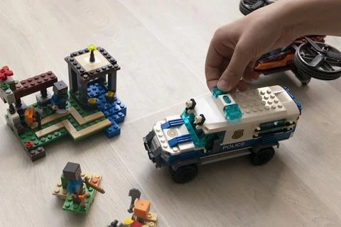 A boy plays collects from the constructor of the car Stock Photos