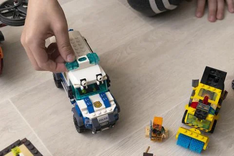 A boy plays collects from the constructor of the car Stock Photos