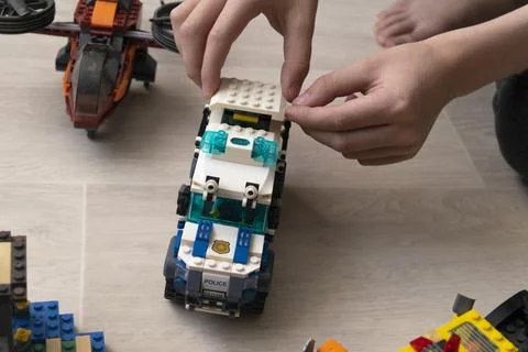A boy plays collects from the constructor of the car Stock Photos