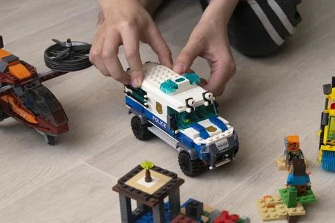 A boy plays collects from the constructor of the car Stock Photos