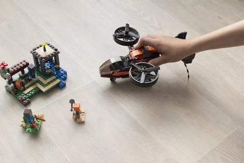 A boy plays collects from the constructor of the helicopter Stock Photos