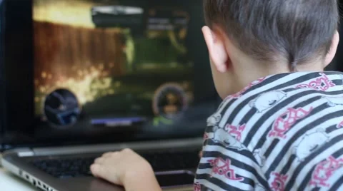 The boy plays on the computer Video stock 60659570