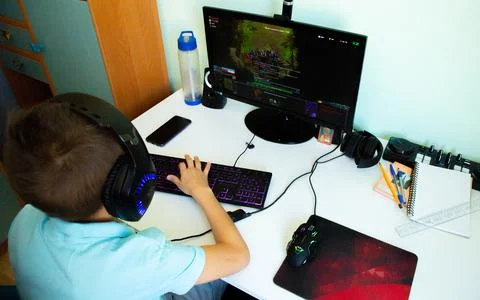 A boy plays in computer game Stock Photos