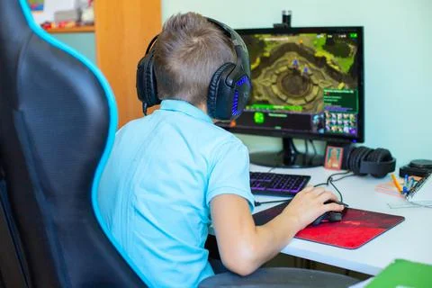 A boy plays in computer game Stock Photos