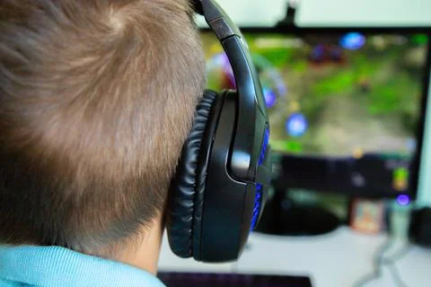 A boy plays in computer game Stock Photos