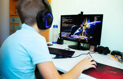 A boy plays in computer game Stock Photos