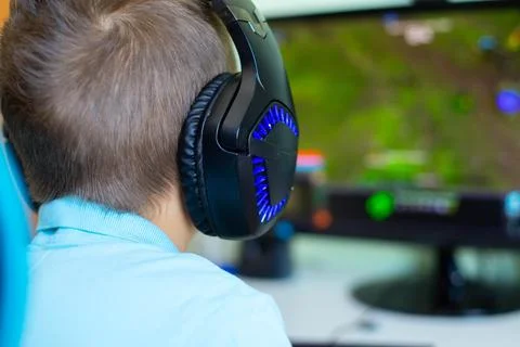 A boy plays in computer game Stock Photos