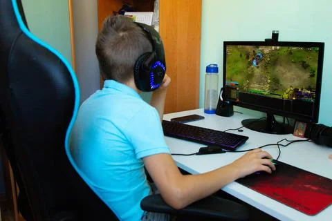A boy plays in computer game Stock Photos