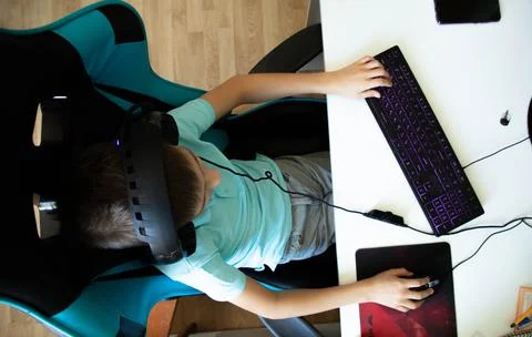 A boy plays in computer game Stock Photos
