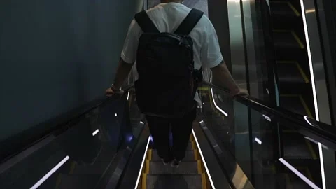 A boy plays dangerously on escalators Stock Footage 135719228