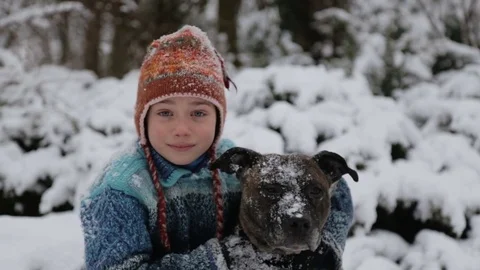 A boy plays with a dog in winter. Stock-Footage 70772841