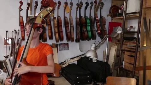 Boy plays the double bass Stock Footage 83434332
