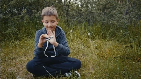 A boy plays with fidget spinner slow motion Stock-Footage 76639807